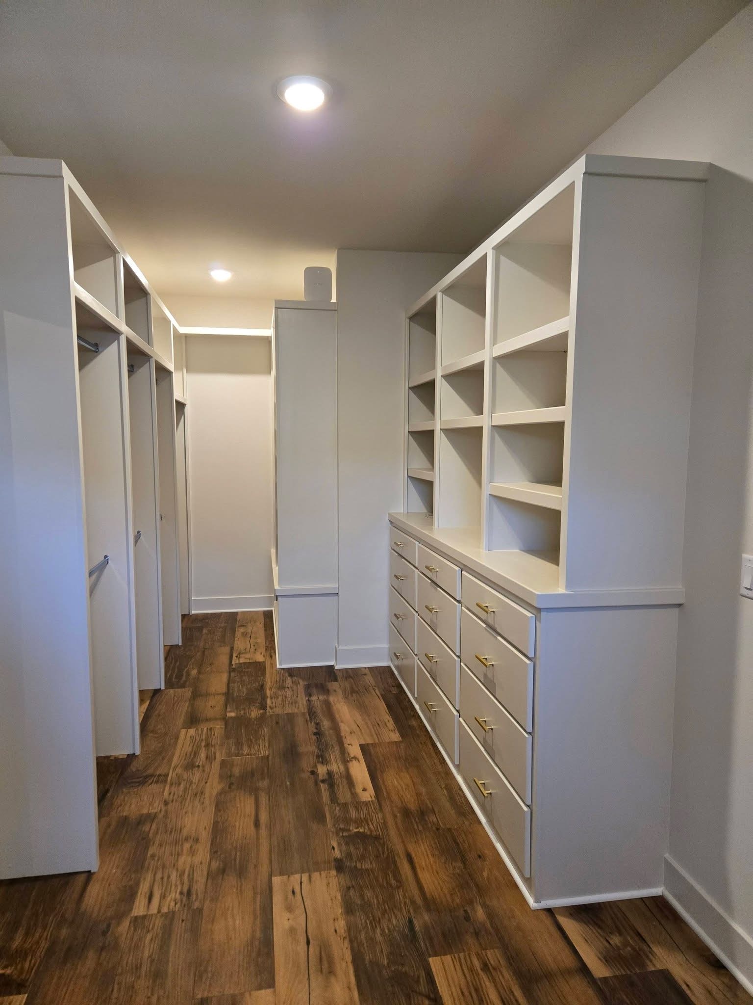 White walk-in closet cabinetry with drawers and shelves